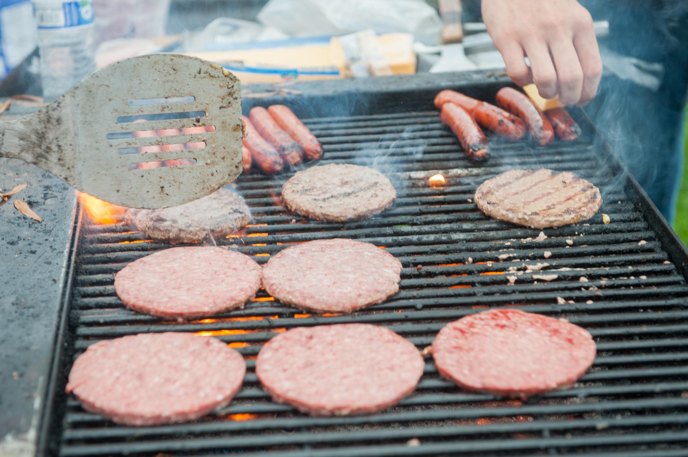 Hamburgers and hotdogs on a grill